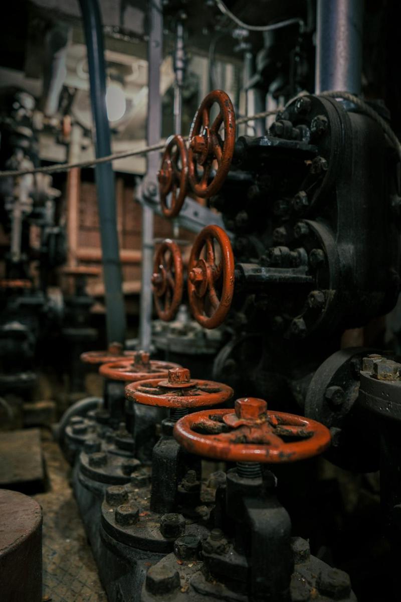 Row of valves with red handwheels