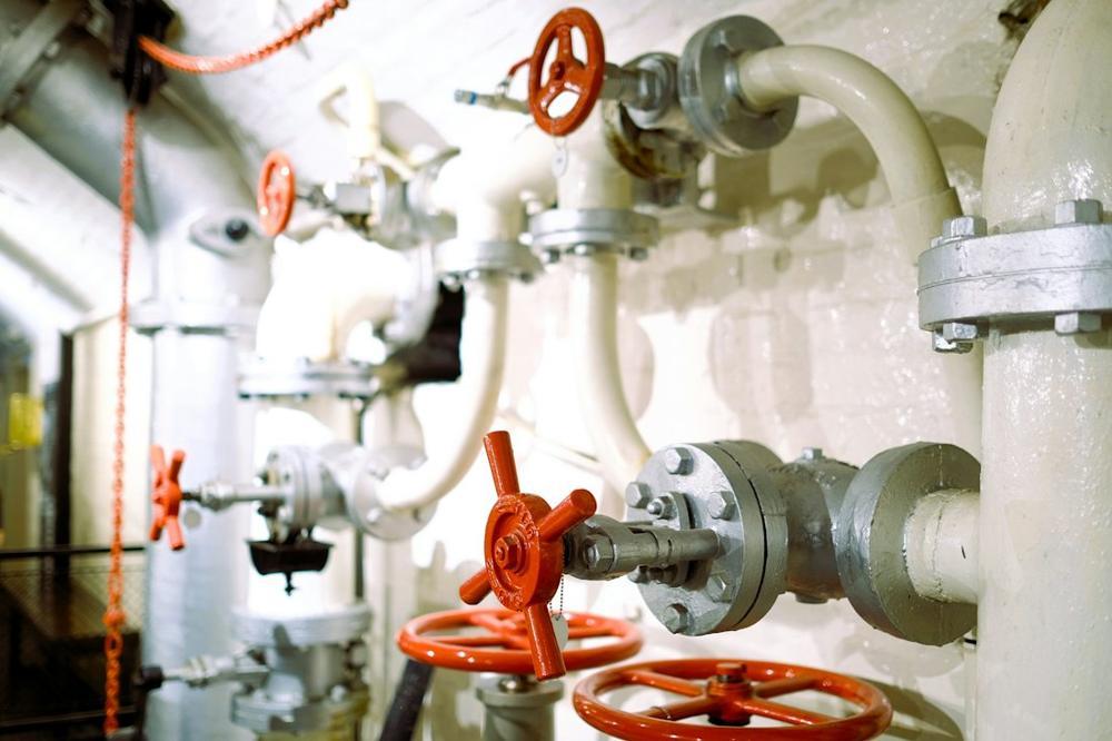 White pipework with red valve handwheels